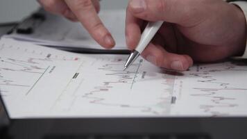 Teamwork of two employees working and entering data on a laptop, reviewing and verifying chart analytics. Concept effective collaboration and data analysis for decision-making. Close-up video