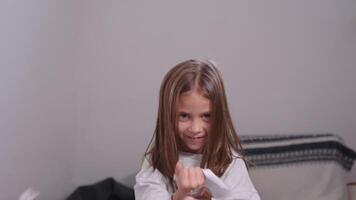 Mischievous girl tearing papers and tossing them in the air at home video