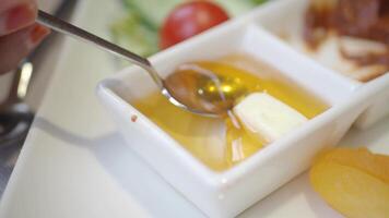 Enjoying a sweet moment with honey and butter for breakfast video