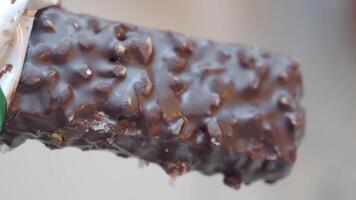Delicious chocolate bar with crunchy texture displayed close up video