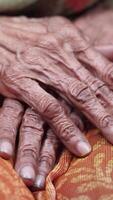 Elderly hands resting on vibrant textile in quiet space video