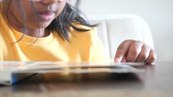 Engaging child reading at a table in a cozy environment video