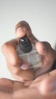 Man applying fragrance with a spray bottle in a bright setting video