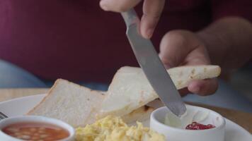 Enjoying a hearty breakfast with toast and eggs in a cozy setting video