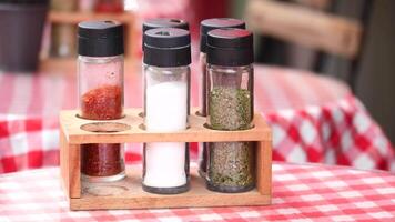 Colorful seasoning display on a checkered table at a local eatery video