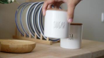Storage jars filled with sugar and tea on a kitchen counter video
