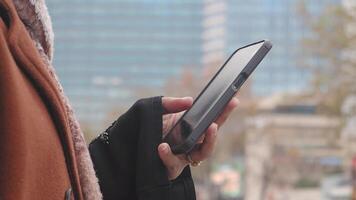 Holding a smartphone in a bustling urban setting video