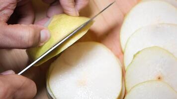 Slicing fresh pear into thin rounds for a tasty dessert or snack video