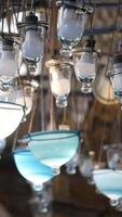 Unique glass lighting fixtures displayed in an artisan shop video