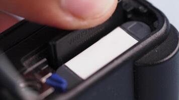 Close-up of memory card insertion into a digital device video
