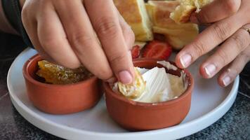 Enjoying traditional snacks with honey and cream at local cafe video