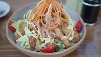 Crispy chicken salad with fresh vegetables in a cozy setting video