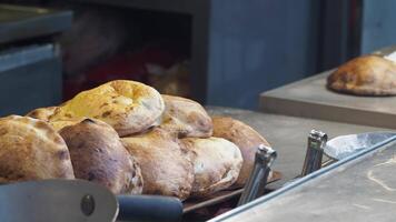 Freshly baked bread displayed in a bustling bakery environment video