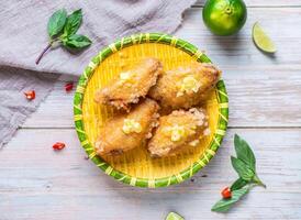 Butter Chicken in French Style with lemon served in plate isolated on wooden background top view of Hong Kong food photo