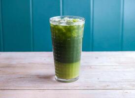 Iced Matcha Lemonade, Ice Mung Bean and Centella Asiatica drink with ice cube served in glass isolated on wooden background side view of Hong Kong drink photo
