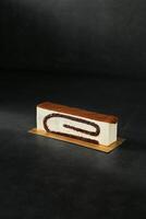 White Chocolate Butterscotch Cake Block isolated on dark background top view of baked item dessert photo