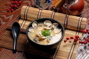 Clam Miso Soup in a dish with chopsticks isolated on mat side view of taiwan food photo