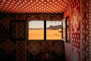 Desert dunes stretch beyond a rustic Bedouin window, capturing the solitude of Wadi Rum. Travel blogs, cultural documentaries, and lifestyle. photo