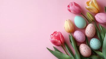 Pastel tulips and colorful Easter eggs on a light pink background, perfect for spring marketing, Easter-themed products. photo