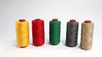 Vertical Color Arrangement of Sewing Thread Spools photo