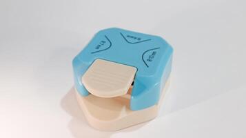 A compact blue mini corner cutter that easily rounds paper photo