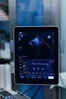 Close-up Ultrasound image on the monitor in the operating room during surgery. Ultrasound scan examination on display. Screening ultrasonography analysis. Echocardiography. Medicine vertical shot photo