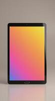 Tablet with colorful background on a table photo