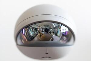 A camera is reflected in a white dome photo