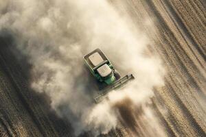 A tractor is spraying dust on a field photo