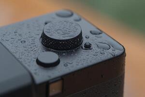 A close up of a camera with water droplets on it photo