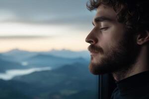 A man with a beard and a beard looking out the window photo