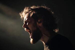 A man with a beard and a beard is screaming photo