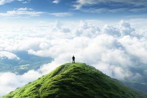 Man standing on top of a mountain in the clouds photo