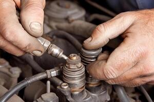 A man is working on a car engine with a wrench photo