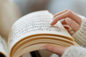 A person is reading a book with music notes photo