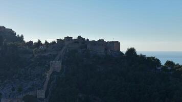 Historic castle ruins on a hilltop with a Mediterranean coastal view video