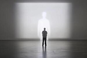 A man stands in front of a large light projection photo
