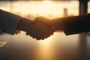 Two people shaking hands over a table with a city in the background photo