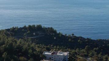 Cable car above lush greenery with a sea view in Alanya, Turkey video