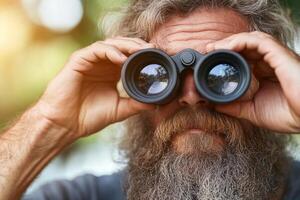 A man with a beard and beard looking through binoculars photo