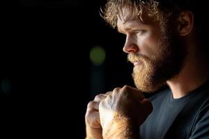 A man with a beard and a beard is looking at something photo