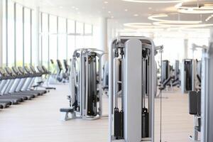 A gym with rows of exercise machines photo