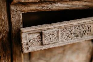 An old wooden drawer with a decorative design photo