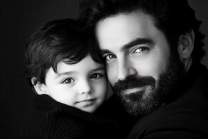 A man with a beard and a child in a black and white photo