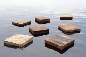 A group of wooden blocks floating in the water photo