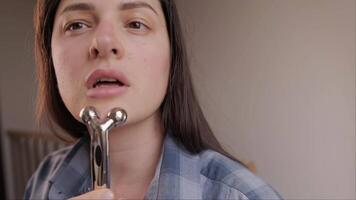 Metal roller for facial massage an natural way to fight wrinkles and reduce puffiness. video