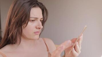 Woman reads the ingredients of a face mask before applying it to her skin. video