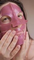 Woman performs a skincare ritual with a hydrogel mask, improving skin condition and providing essential vitamins. video