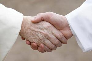A close up of two people shaking hands photo