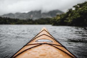 A kayak on the water with mountains in the background photo